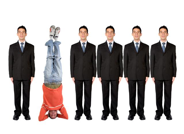 business people in a series with a casual guy doing the headstand